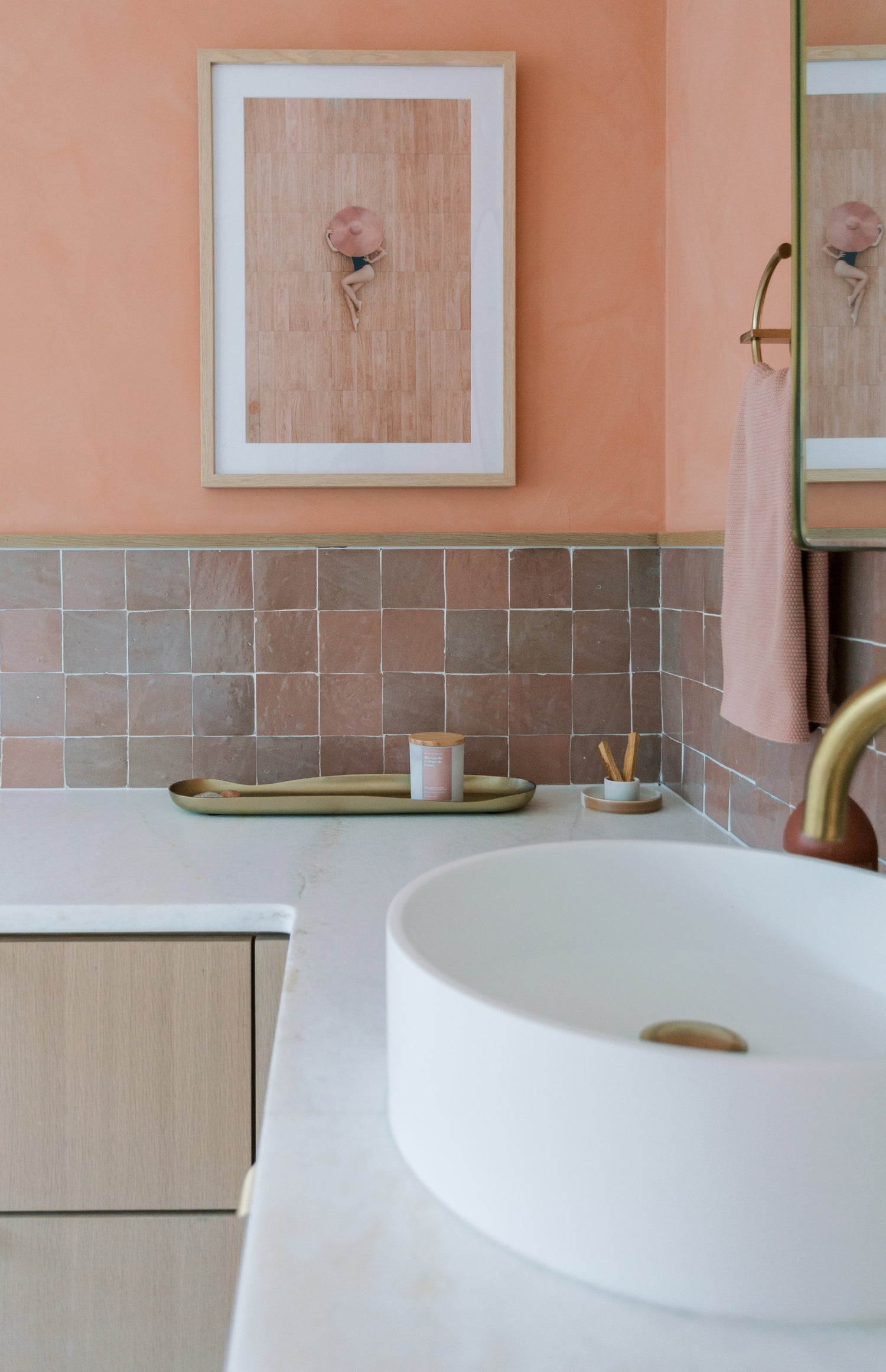pink square zellige tile installed as backsplash in a bathroom