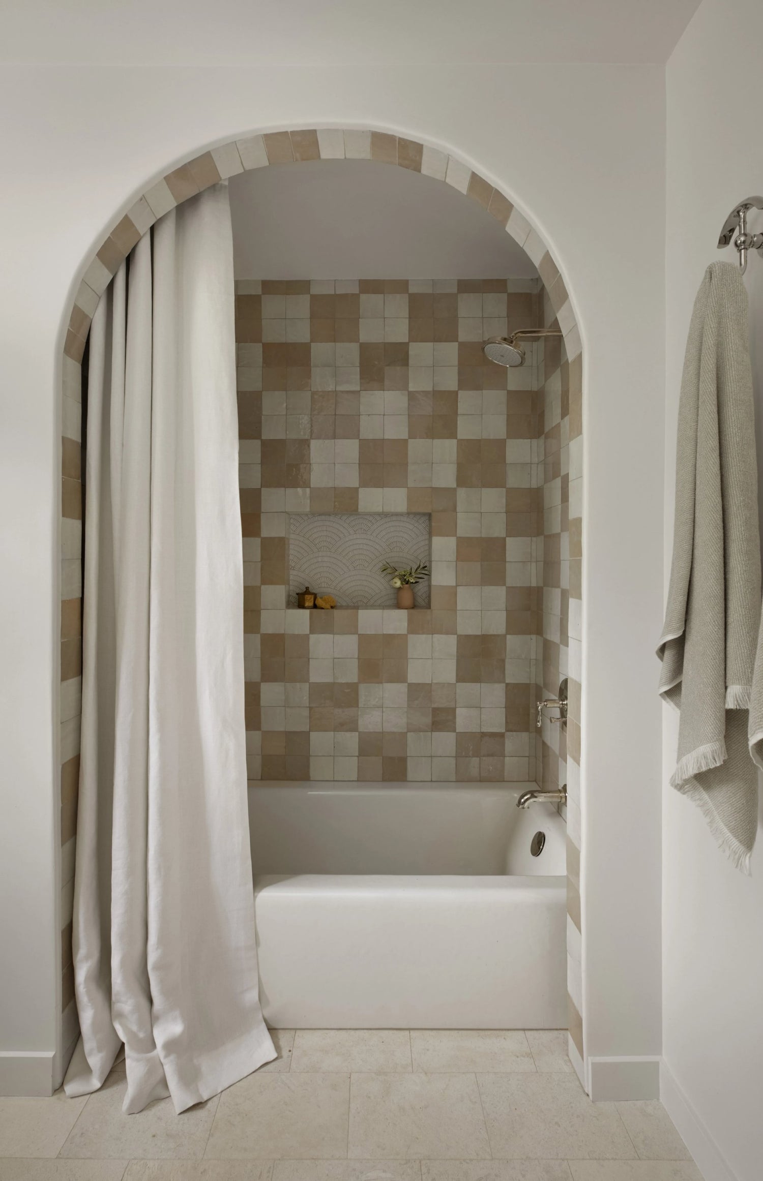 white and beige square zellige tile installed as a checkerboard pattern in a shower