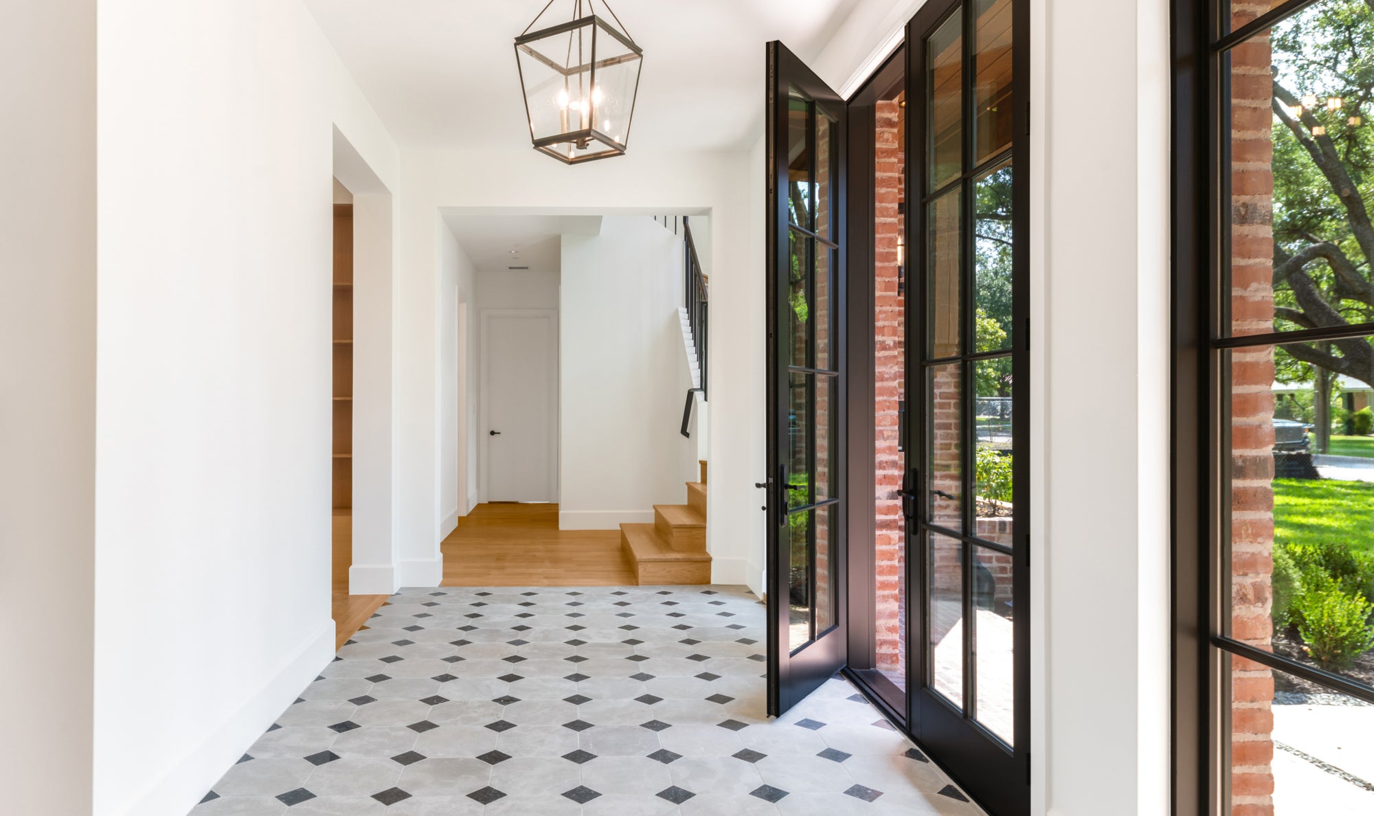 grey and black limestone and marble checkerboard flooring in entryway