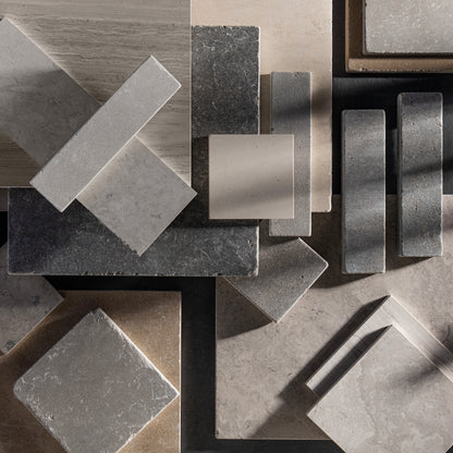 Collection of limestone tiles in different shapes and colors.