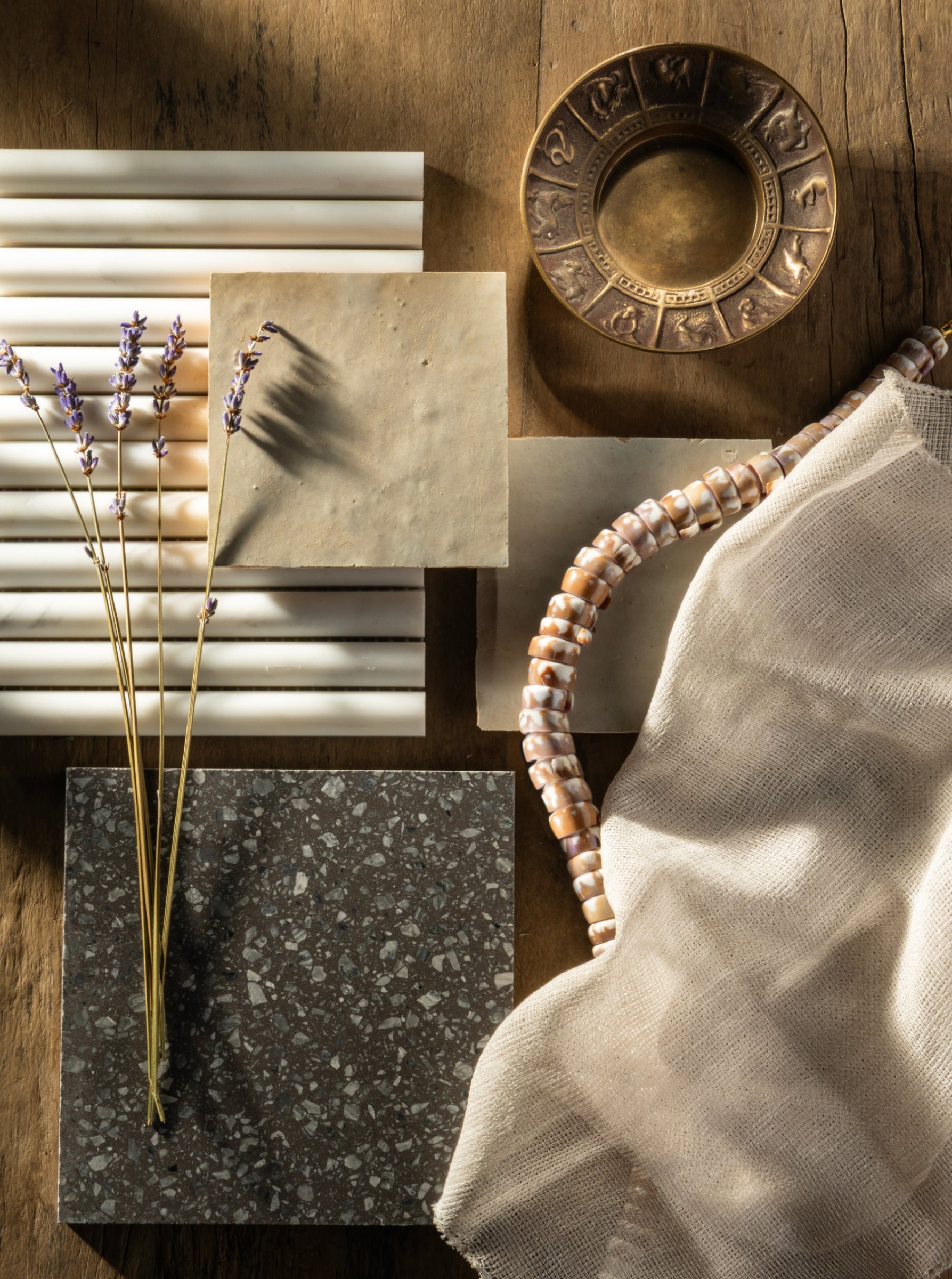 Collage of various textured materials and objects on a wooden surface