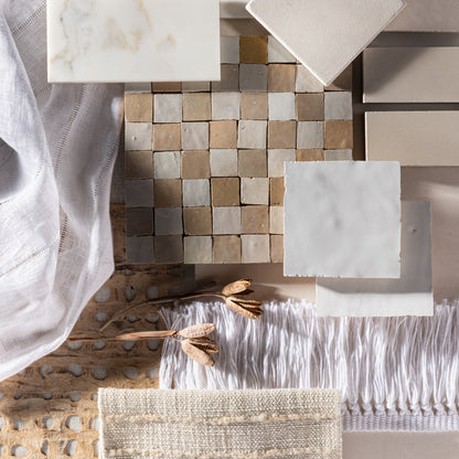 moodboard of beige and white zellige and marble tile with some fabric layered in