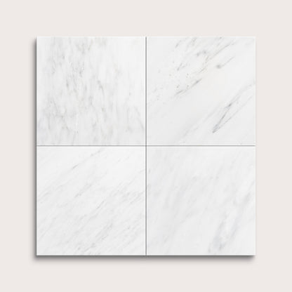 White casablanca carrara marble tiles arranged in a grid pattern on a light gray background