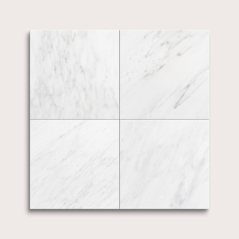 White casablanca carrara marble tiles arranged in a grid pattern on a light gray background