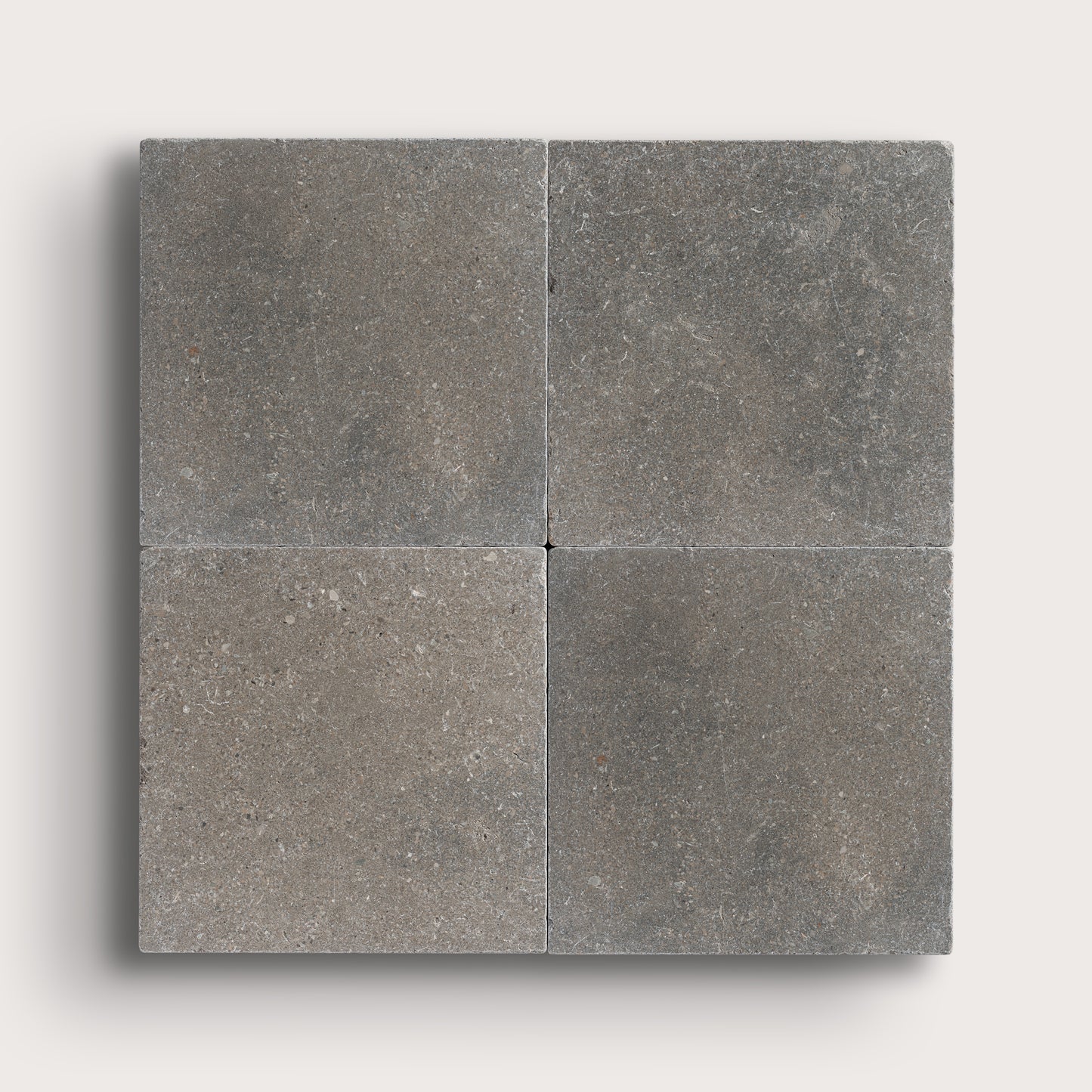 grey square limestone tile in grid pattern on light grey background