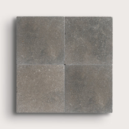 grey square limestone tile in grid pattern on light grey background
