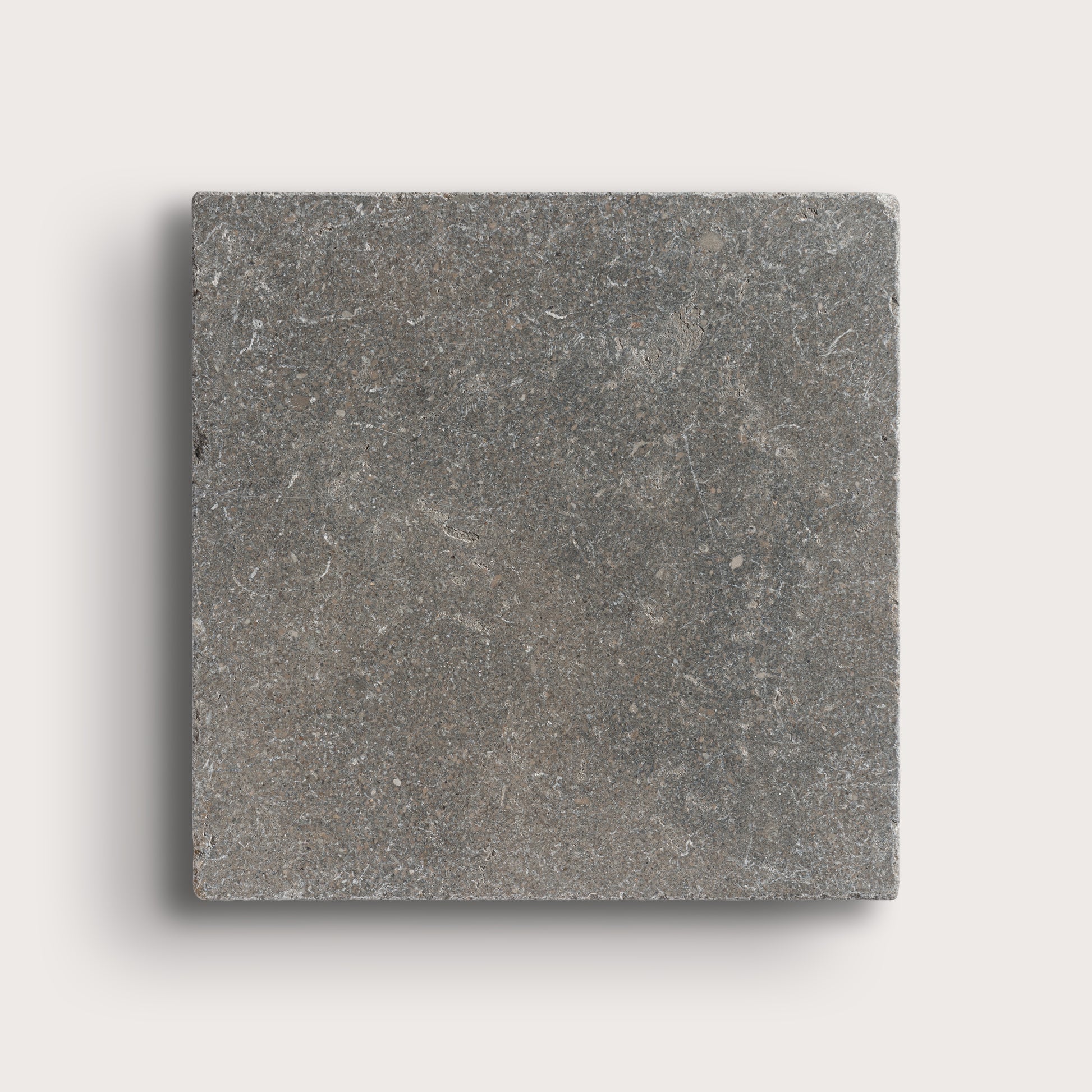 grey square limestone tile on light grey background