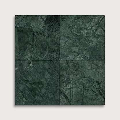Four green marble tiles arranged in a grid on a light gray background