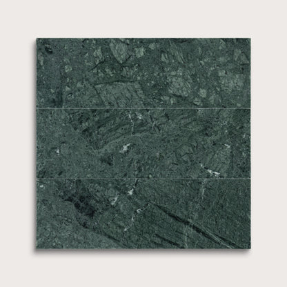 Green marble tiles arranged in a grid pattern on a white background