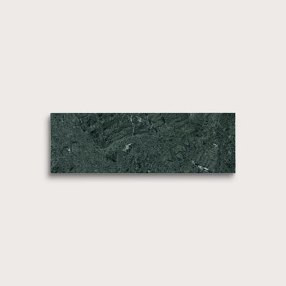 Green marble tile on a light gray background