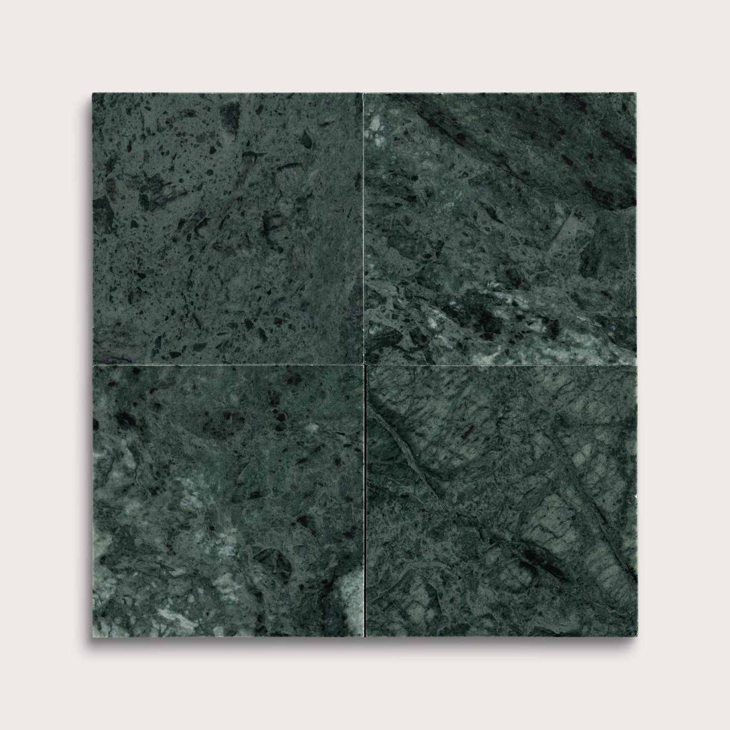 Four square tiles with a dark green marble pattern on a white background