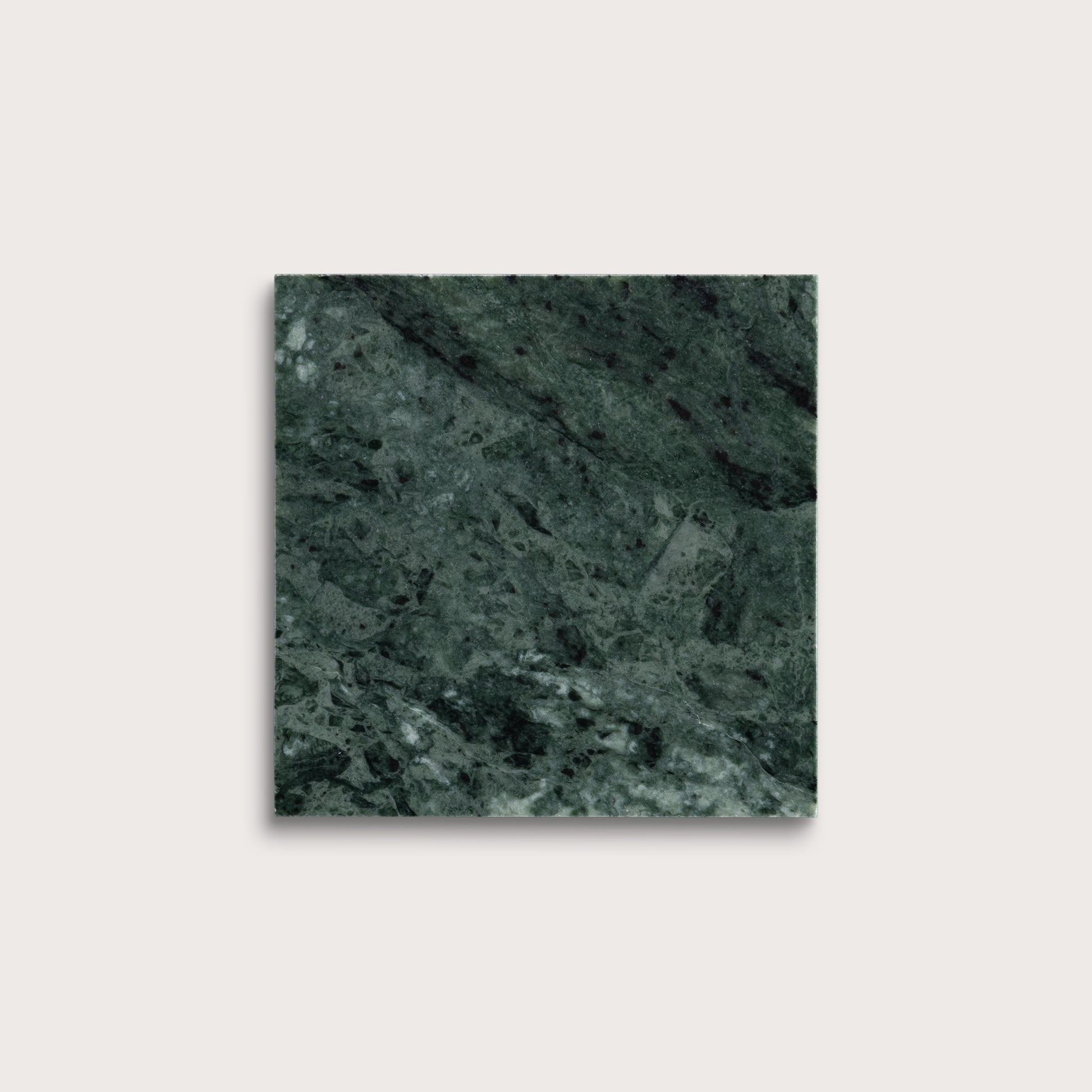 Square tile with a green marble pattern on a light gray background