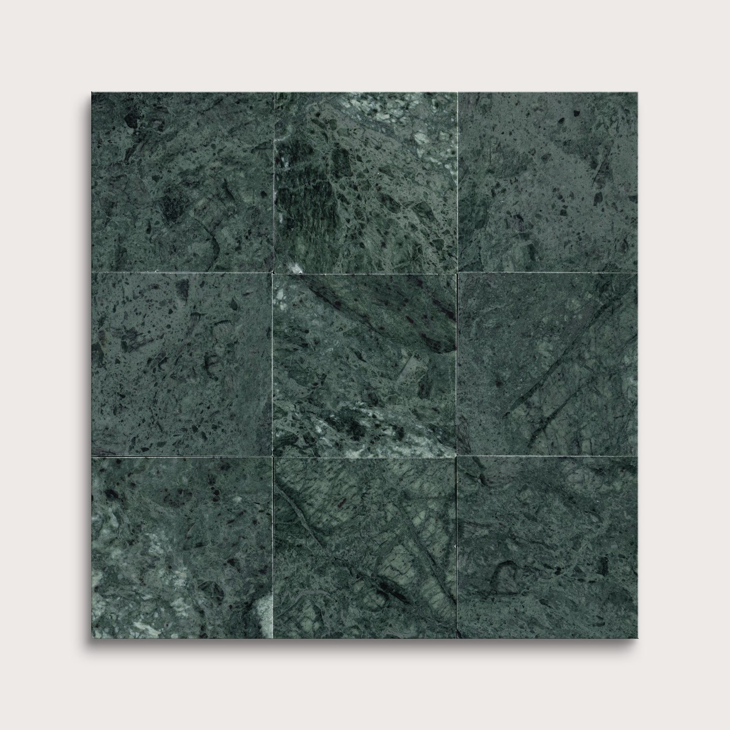 Dark green marble tiles arranged in a grid pattern on a white background