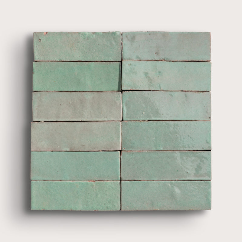 Set of green zellige tiles on a white background