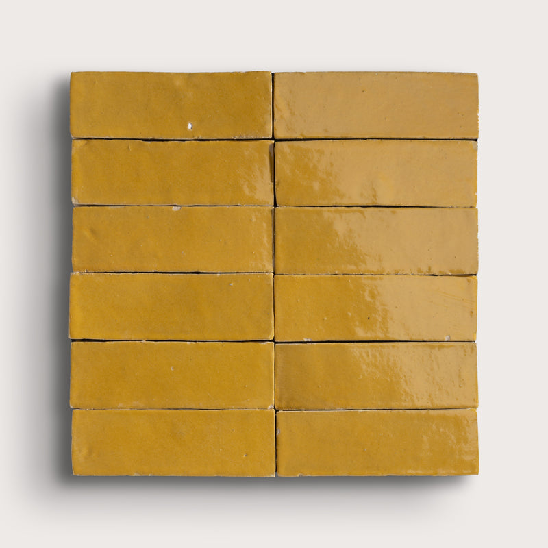 Grid of yellow rectangular zellige tiles on a white background