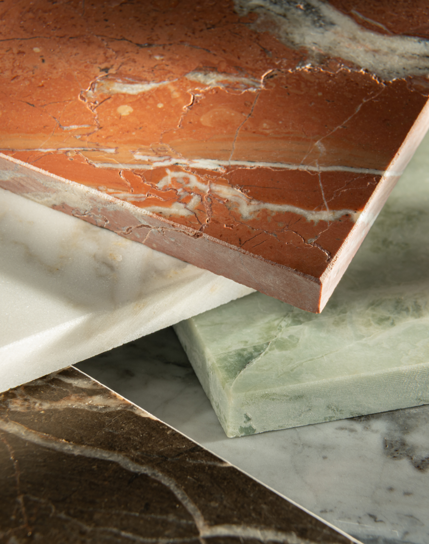 Close-up of various marble tiles with different patterns and colors.
